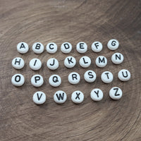 1 Black and white flat round letter bead