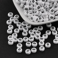 1 Black and white flat round letter bead